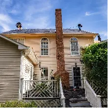 Roof repair on old home with brick chimney